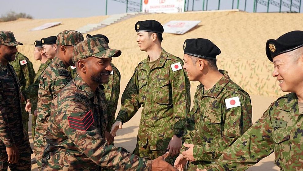 Troops of the Indian Army and Japanese Army exchange greetings during the opening ceremony of Joint Military Exercise ‘Dharma Guardian’ (Credits: ANI)